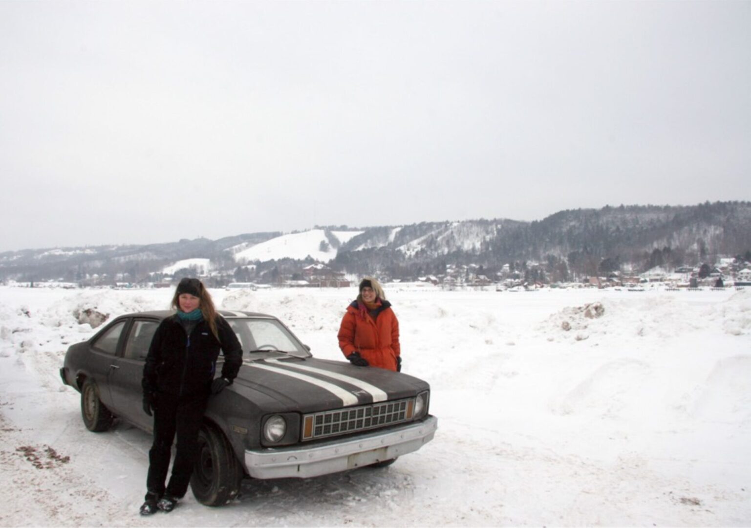 Mary Carothers and Sue Wrbican standing along with car on the snowy path